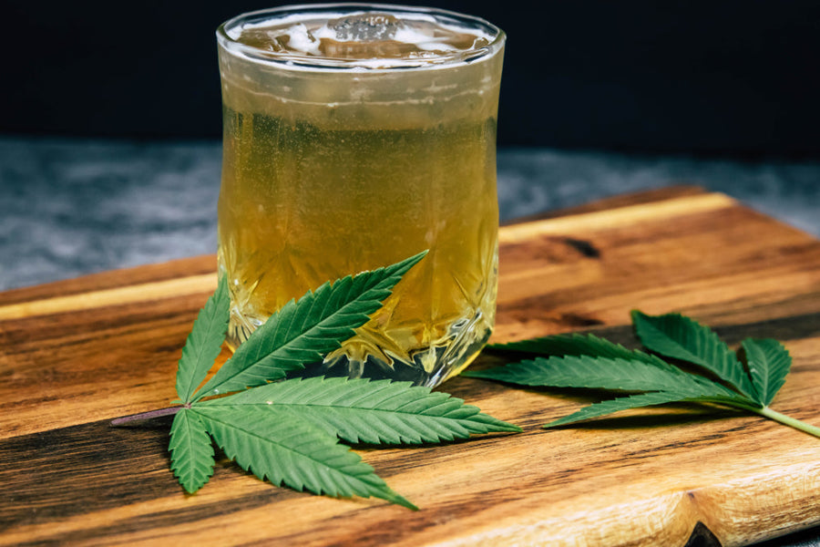 Hemp Leafs Next To Glass Cup
