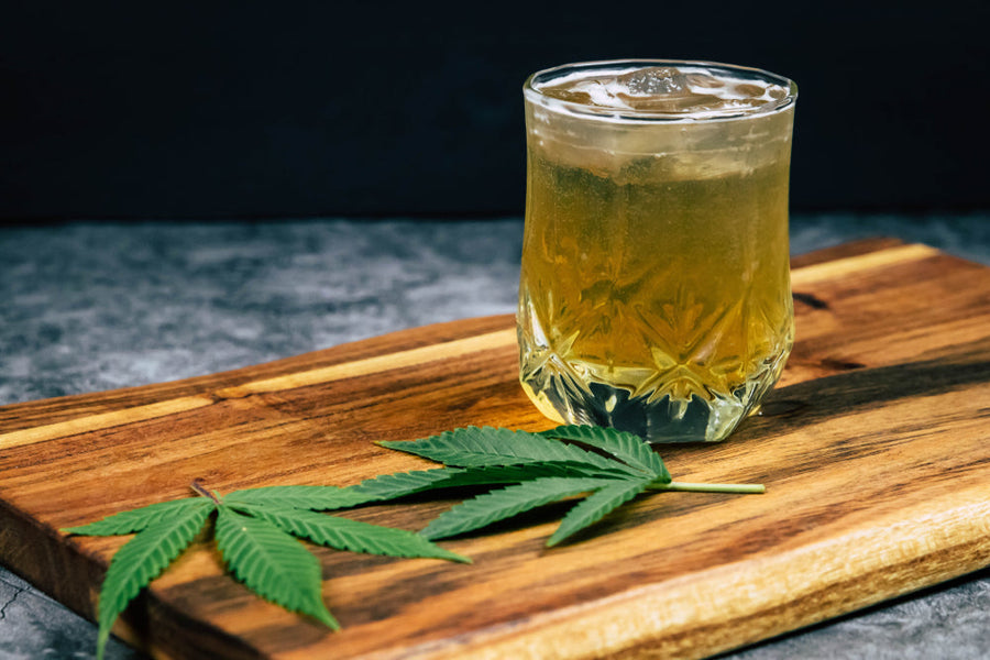 Hemp Leafs Next To Glass Cup