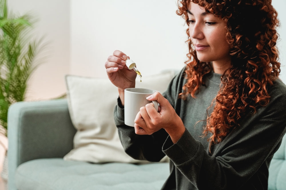 Lady Using Glass Dropper For Mug