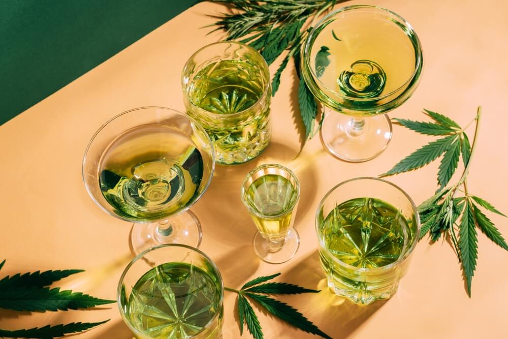 Lots Of Wine And Glass Cups Next To Hemp Leafs