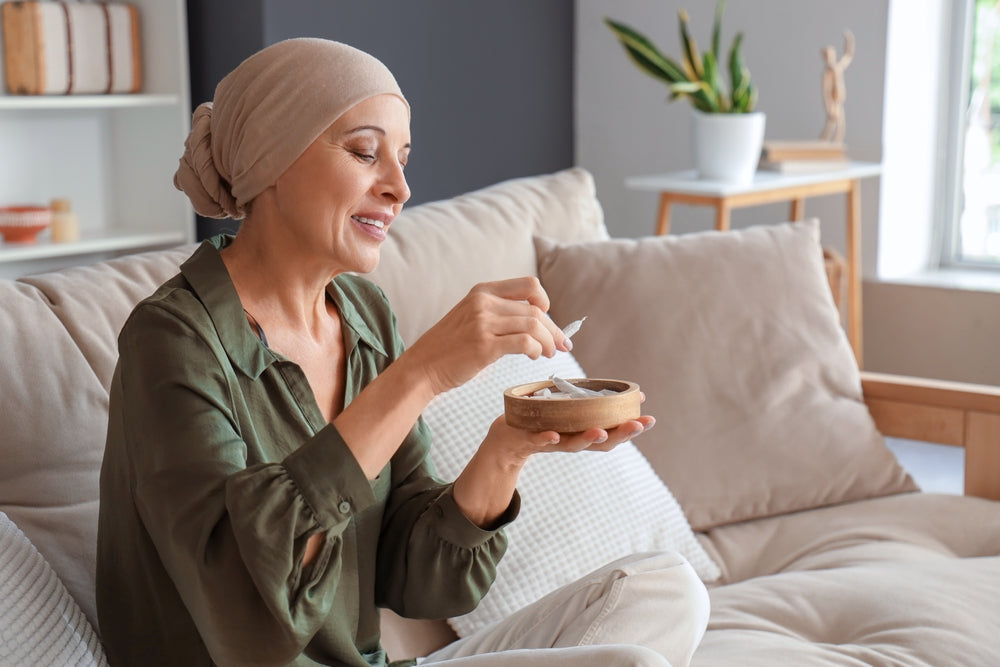 Woman Sitting On Couch With Bowel In Hand